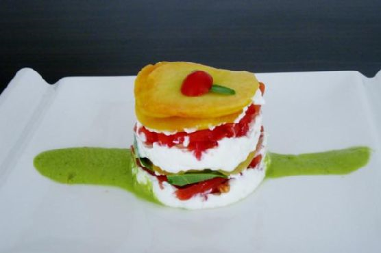 Peaches, tomatoes, and goat cheese layer cake with a peach-basil sauce